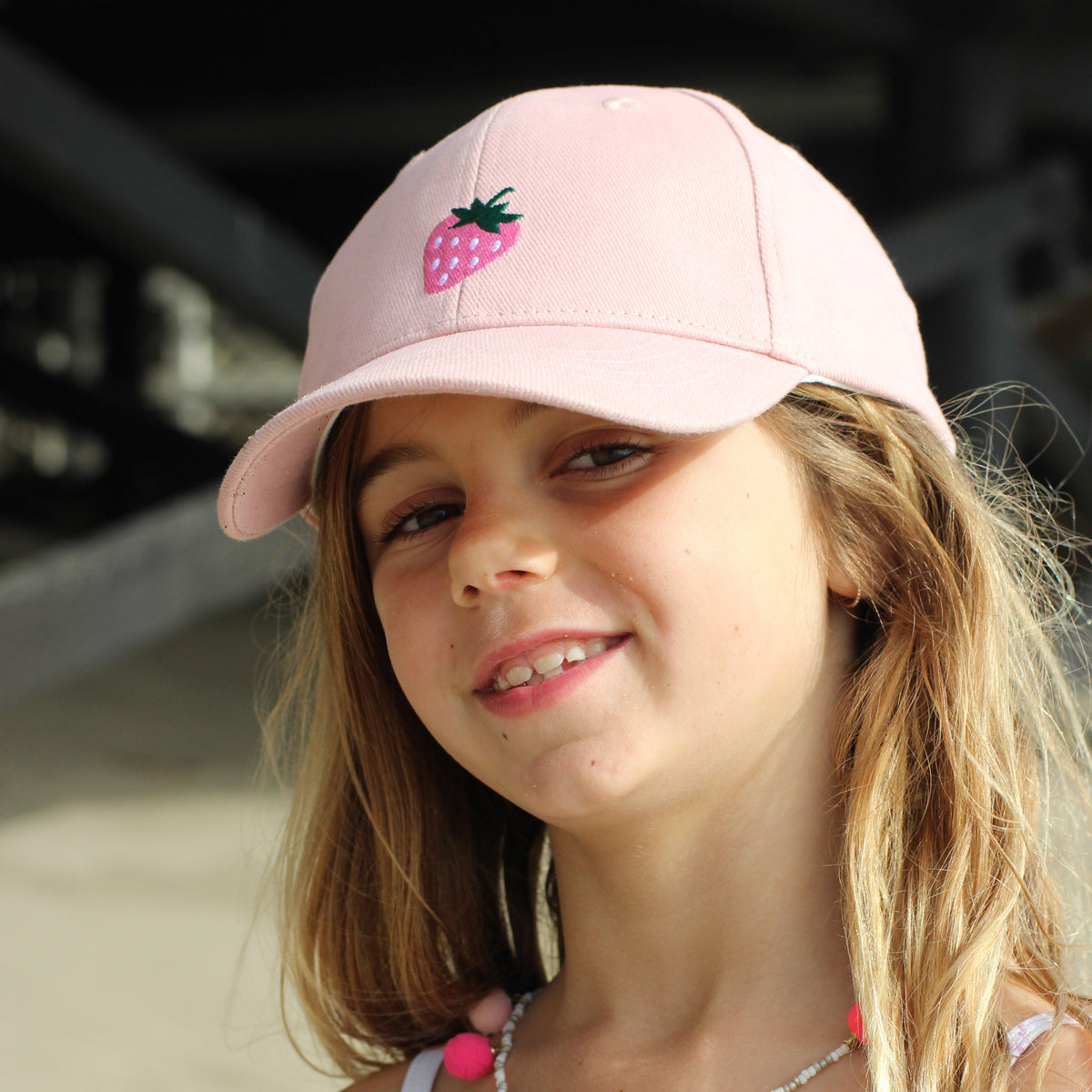 Girls pastel pink baseball cap with embroidered strawberry on front
