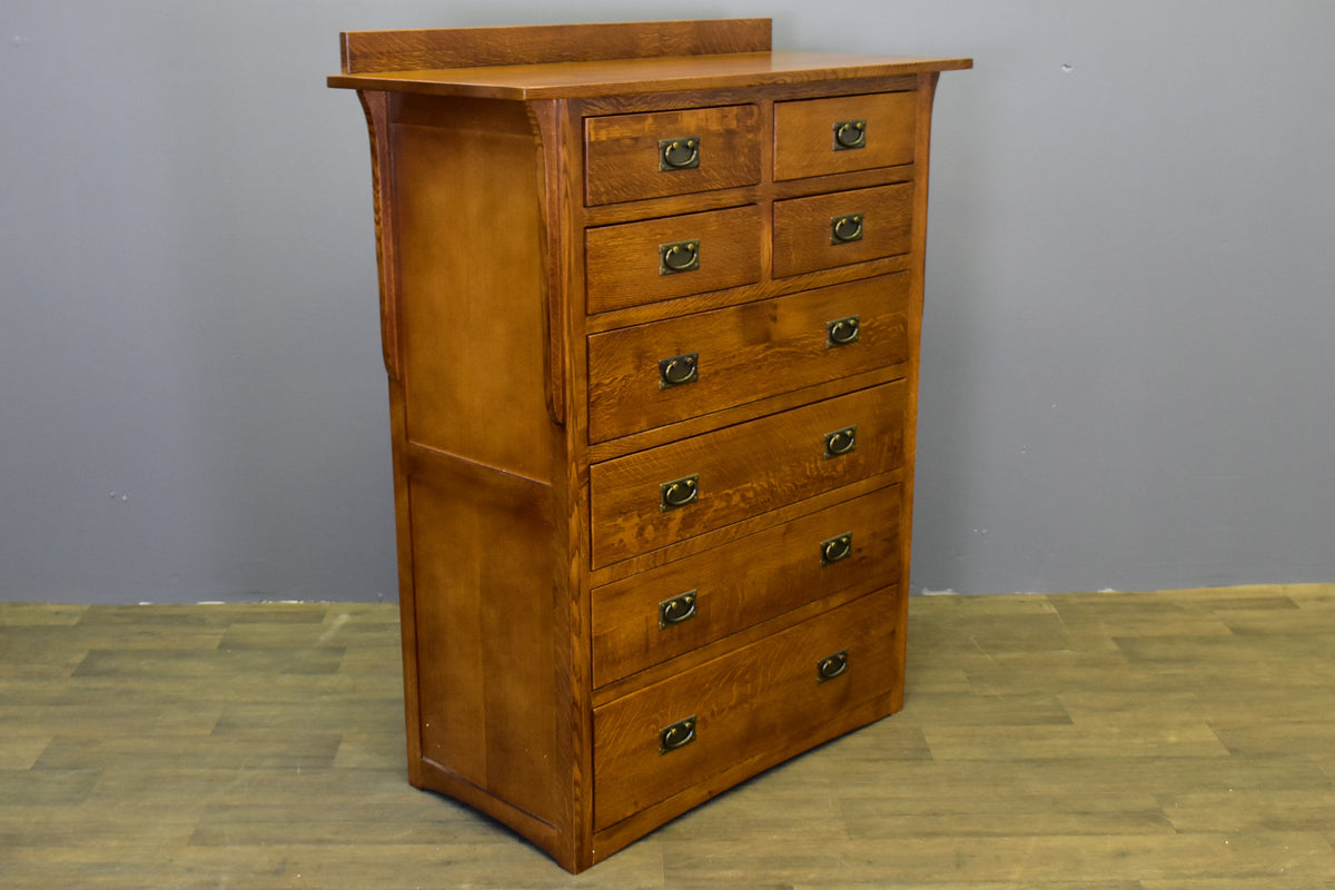 Side view of 8-drawer dresser with solid wood paneling and black cup pulls