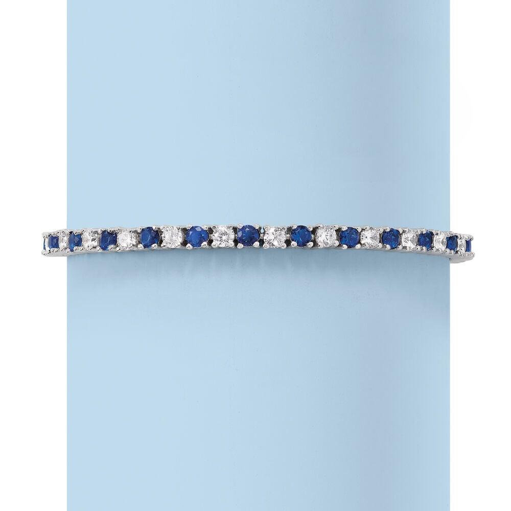 Blue and clear stone tennis bracelet with straight row design, hinged closure