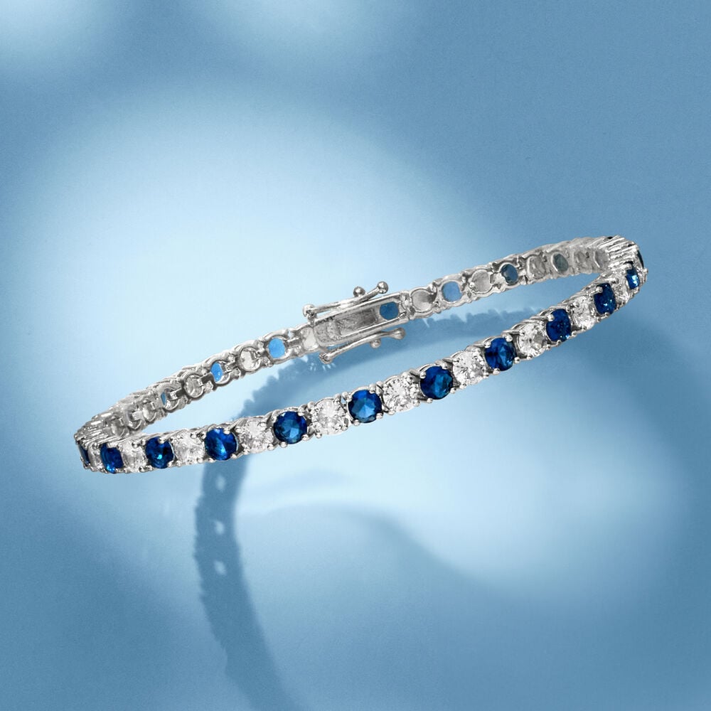Tennis bracelet with alternating blue and clear round stones, hinged clasp