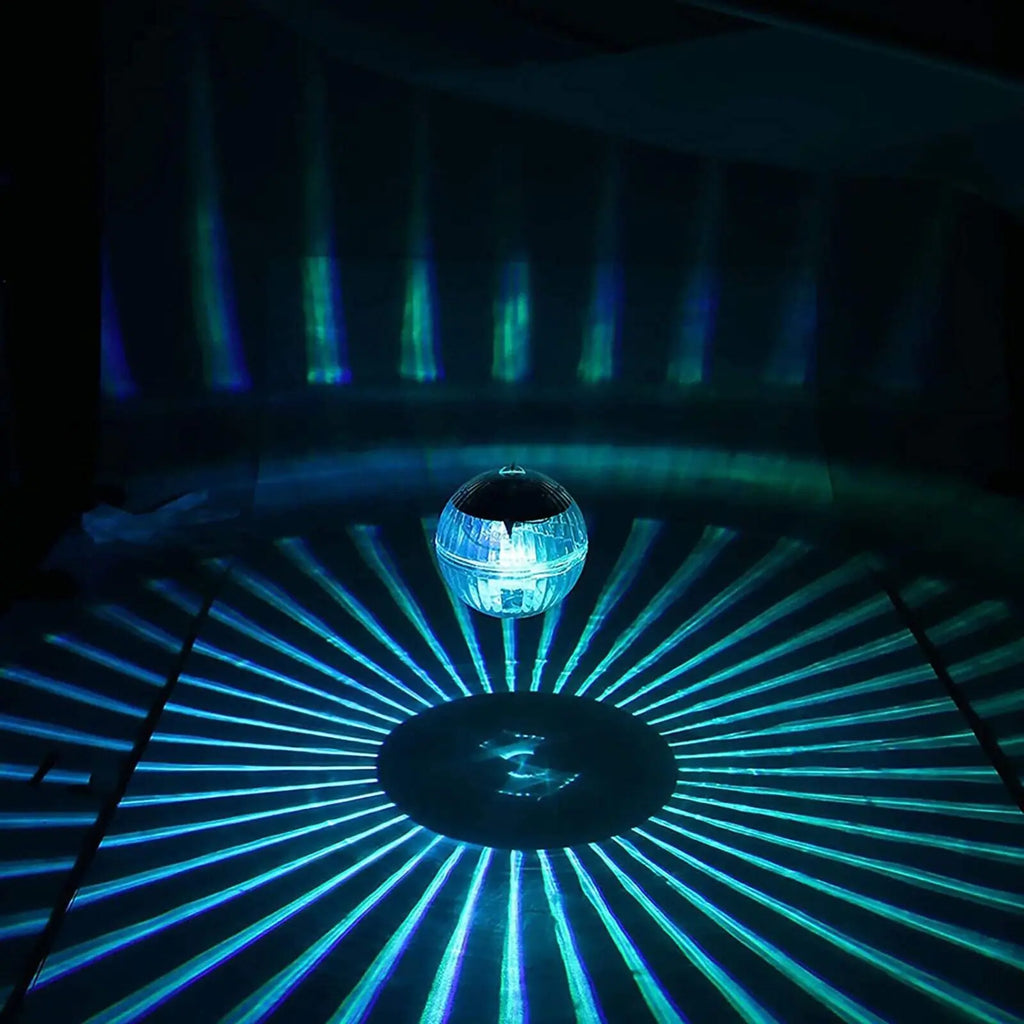 Solar LED floating dome lamp glowing blue with long radial light rays