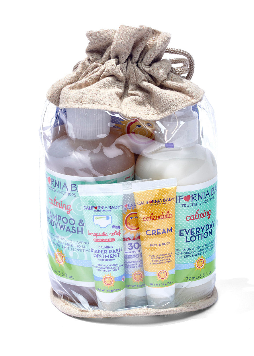 Newborn tote gift set in clear bag with beige drawstring, featuring baby lotion and cream