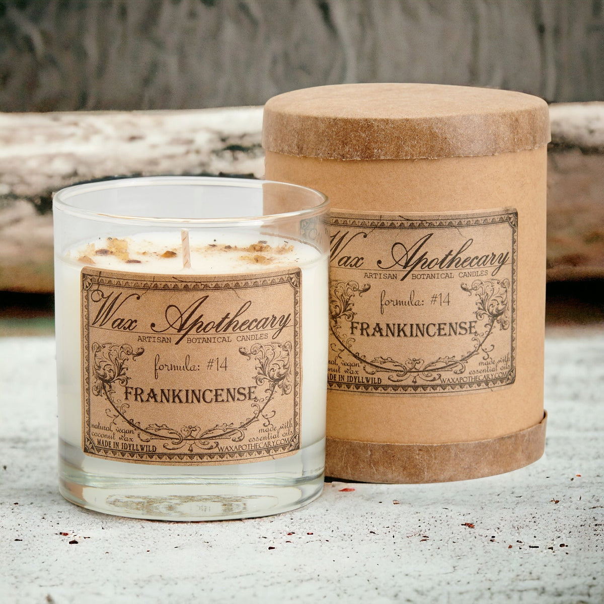 Botanical candle in clear scotch glass with Frankincense label, paired with kraft sleeve