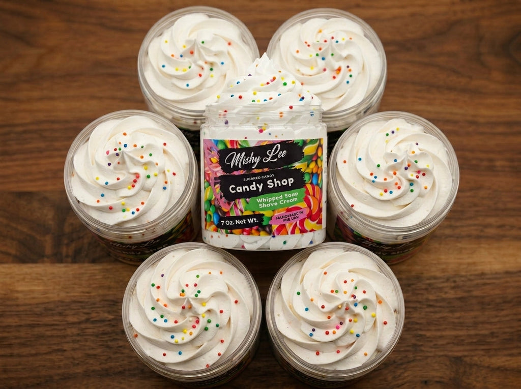 Five Mishy Lee whipped soap tubs with colorful sprinkles on wooden tabletop