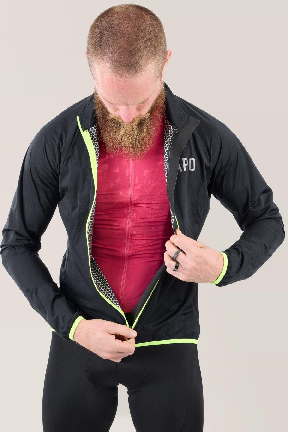 Black rain jacket open at front, neon lime trim, showing inner lining