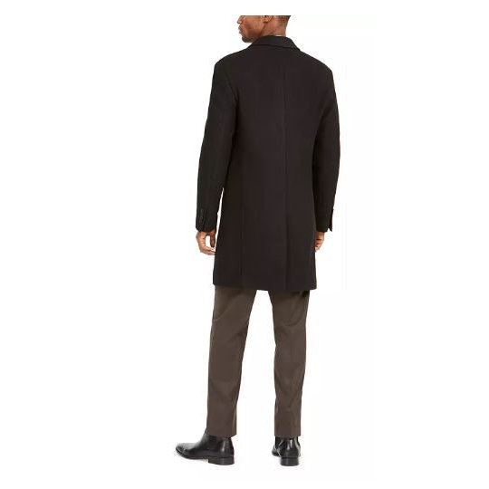 Black overcoat back view with full-length sleeves and center seam