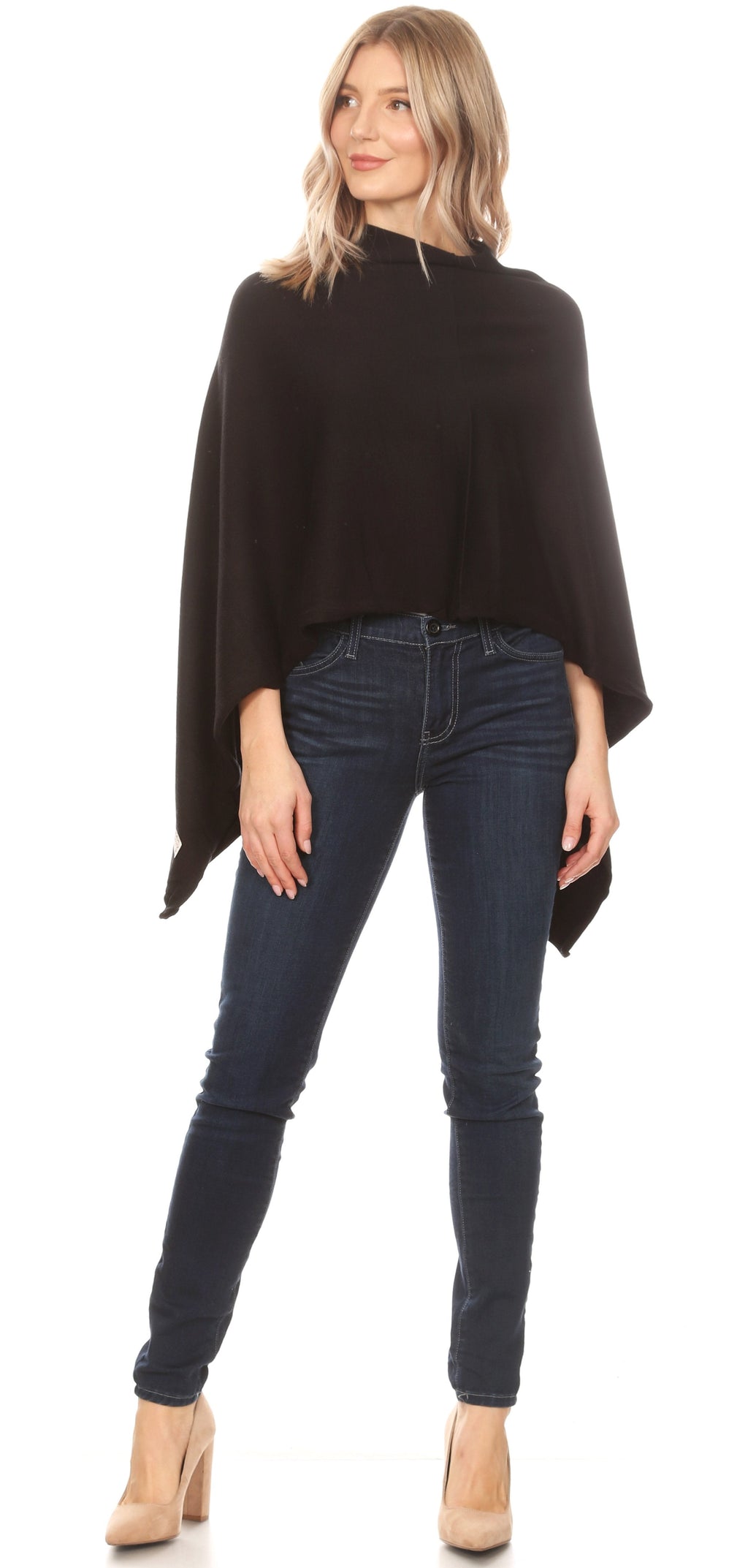Black cape poncho pullover with side points, high neckline, worn over jeans