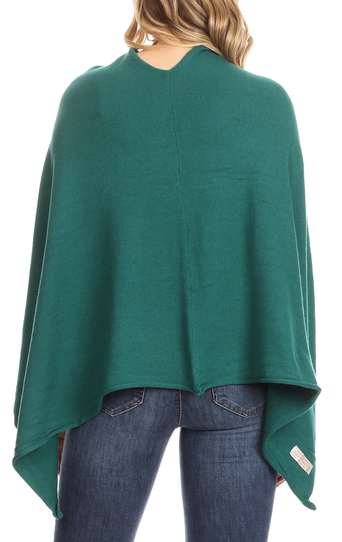 Dark green cape poncho pullover shown from back with flowing hem and high neckline