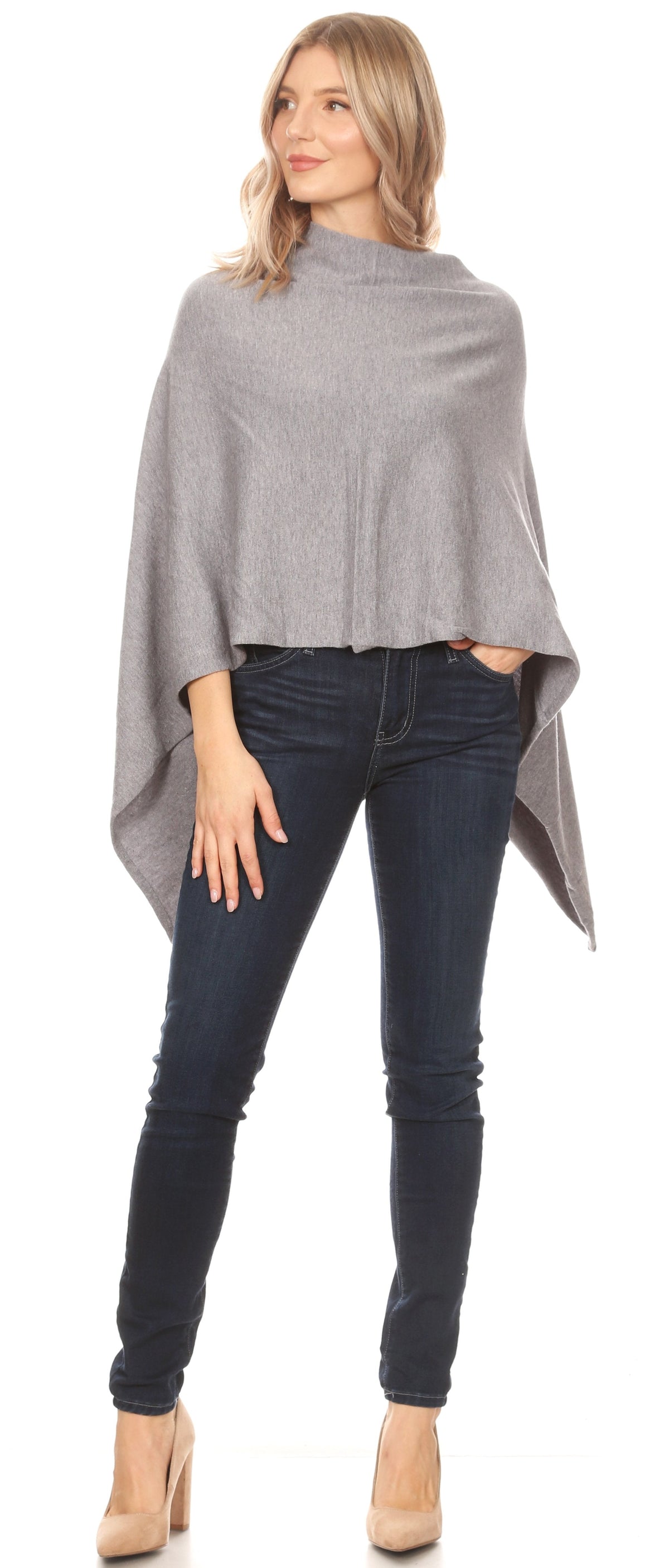 Women’s grey cape poncho with poncho silhouette and side slit hem over dark jeans