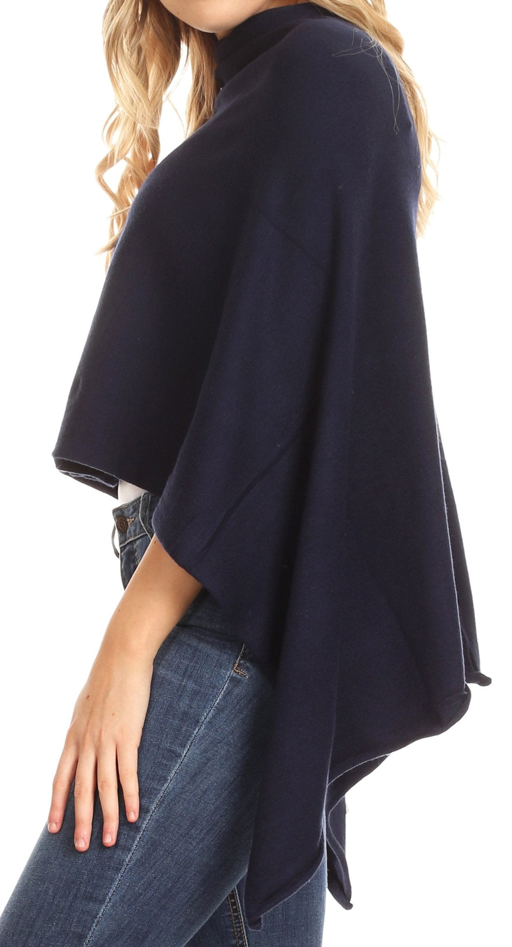 Women’s navy cape poncho with flowing side panels over blue jeans