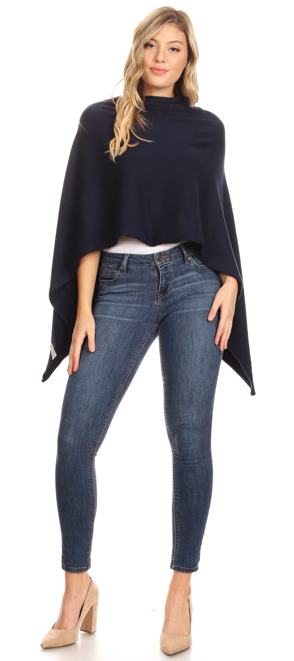 Women’s navy cape poncho with loose fit and side slit hem over blue jeans