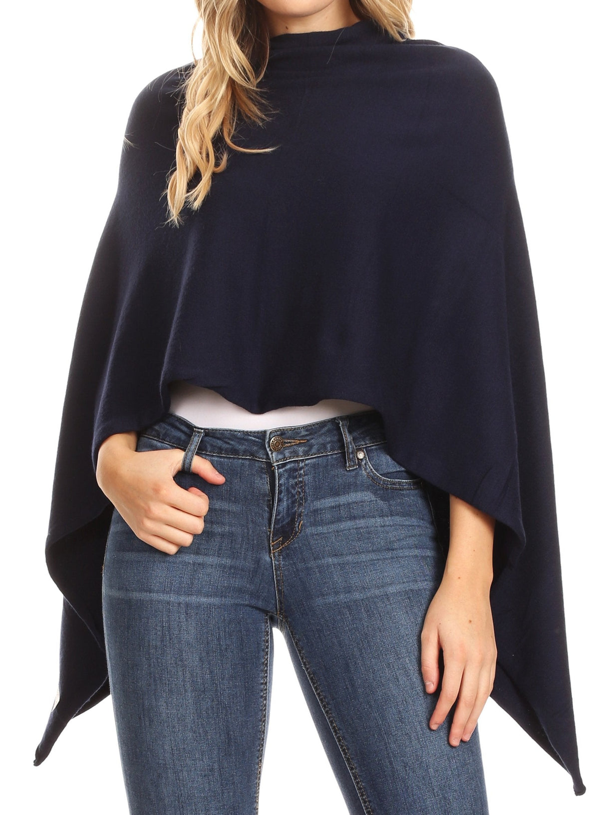Women’s navy cape poncho with draped sleeves and high neckline over blue jeans