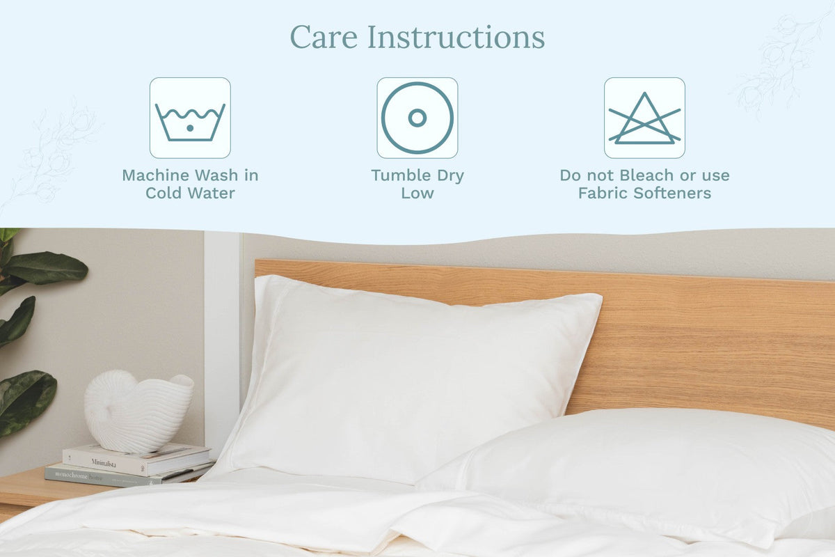 White pillowcase on bed, care instruction icons above the bedding