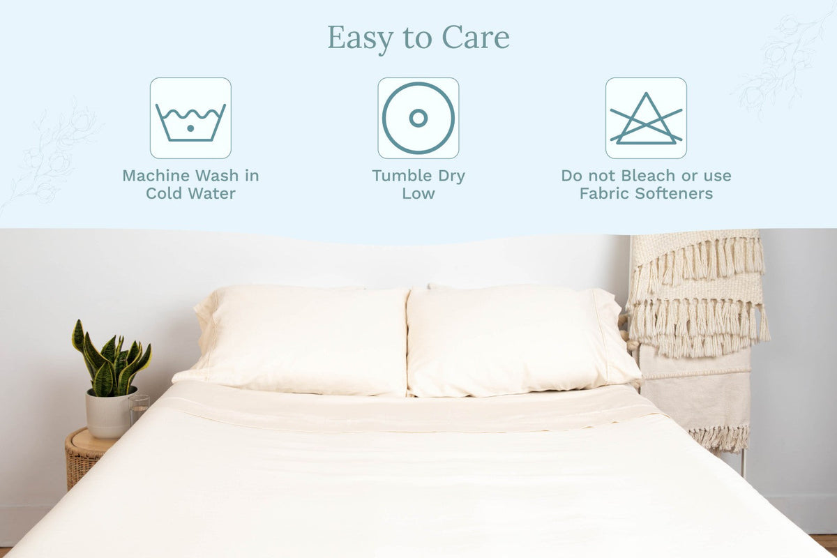 White bed sheet set on a bed with matching pillows