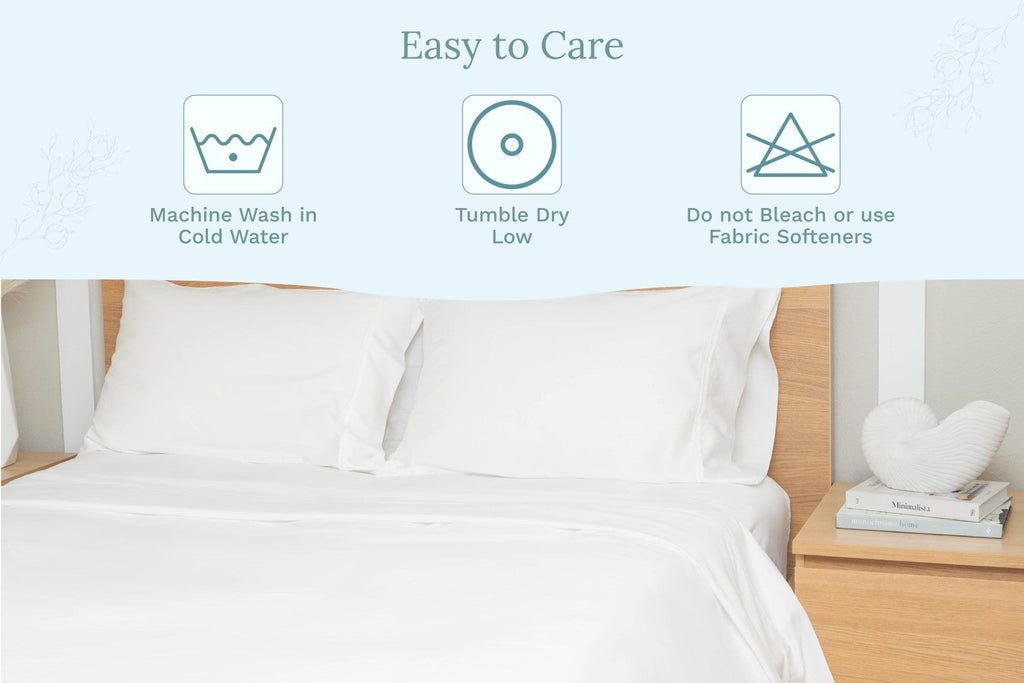 White sateen bed sheet set on a bed with matching pillows