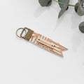 Zero waste luggage tag, cork-look fabric with “COURAGE” and gold-toned metal loop