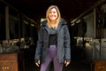 Black insulated riding jacket with hood and front zipper