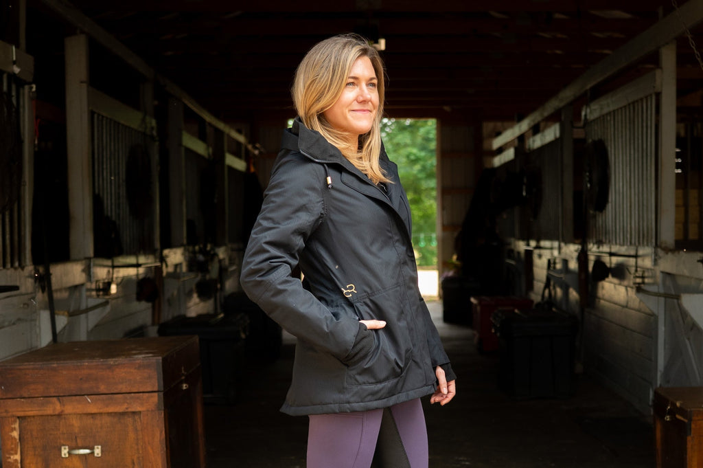 Black insulated riding jacket with hood, zip front, and hand pockets