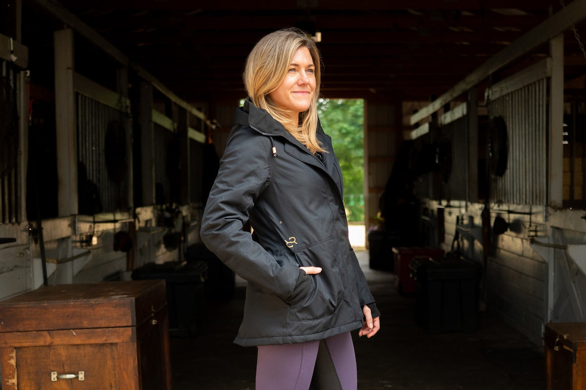 Black insulated riding jacket with hood, zip front, and hand pockets