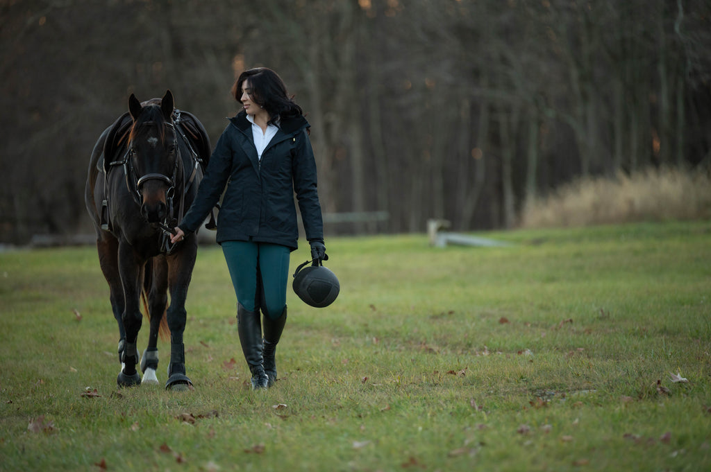 Dark insulated riding jacket with front buttons and long sleeves