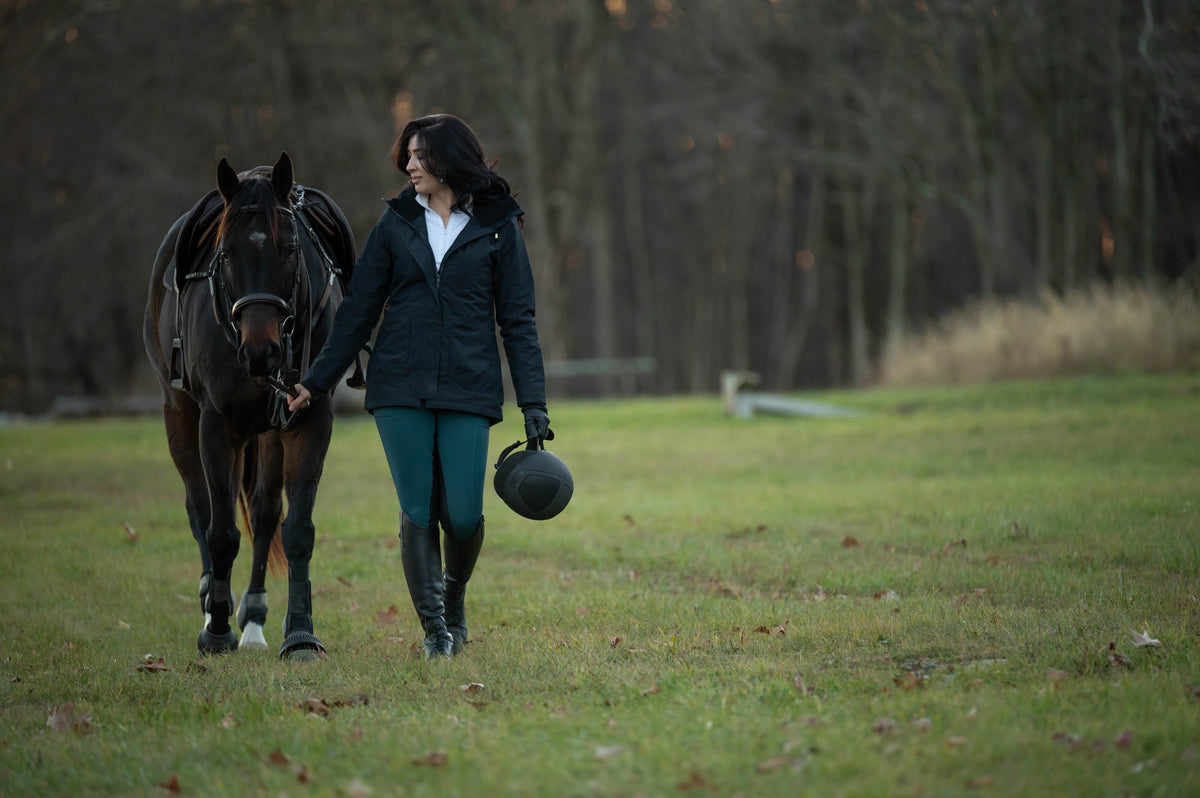Dark insulated riding jacket with front buttons and long sleeves
