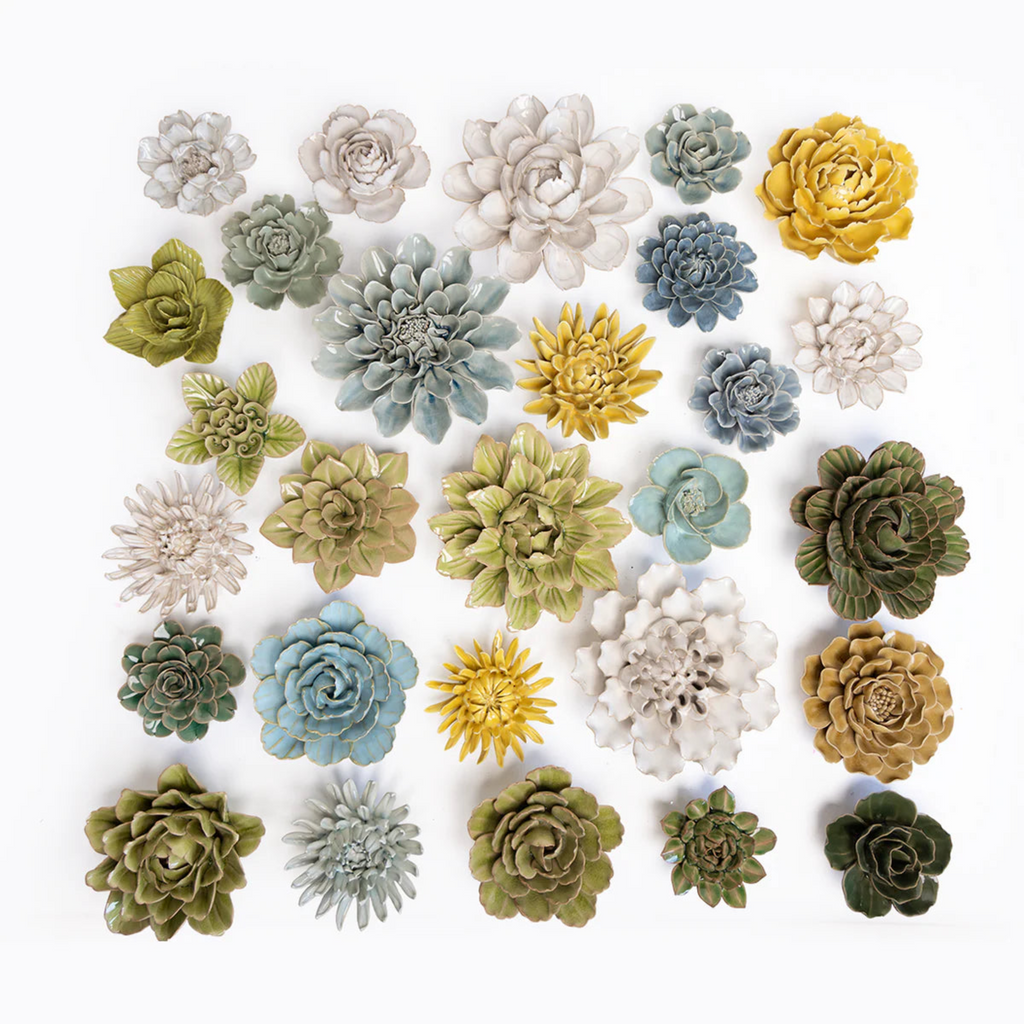 Assorted ceramic flower wall art pieces with layered rosette petals in mixed colors