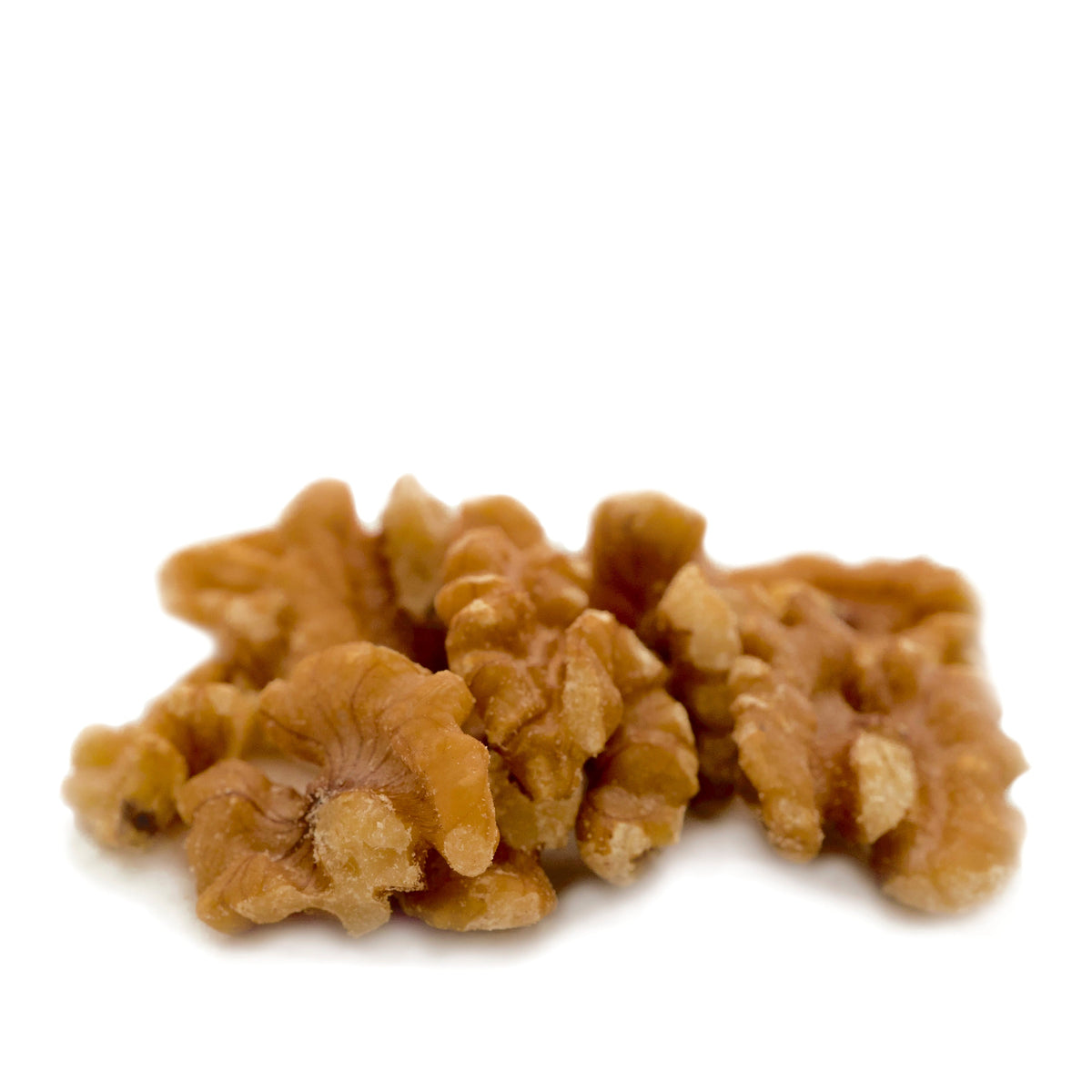 Pile of walnut halves and pieces in a close-up view