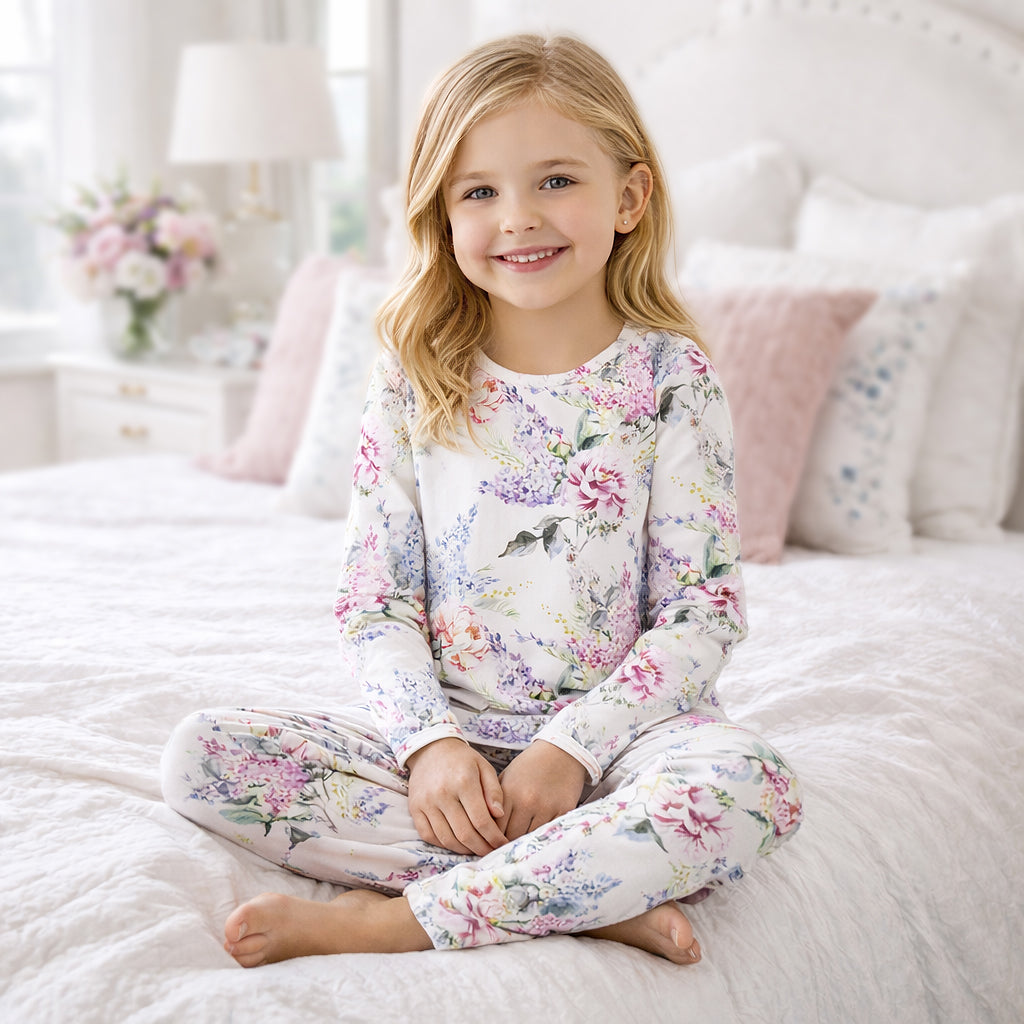 Kids bamboo pajama set with long sleeves and pants, white floral print.