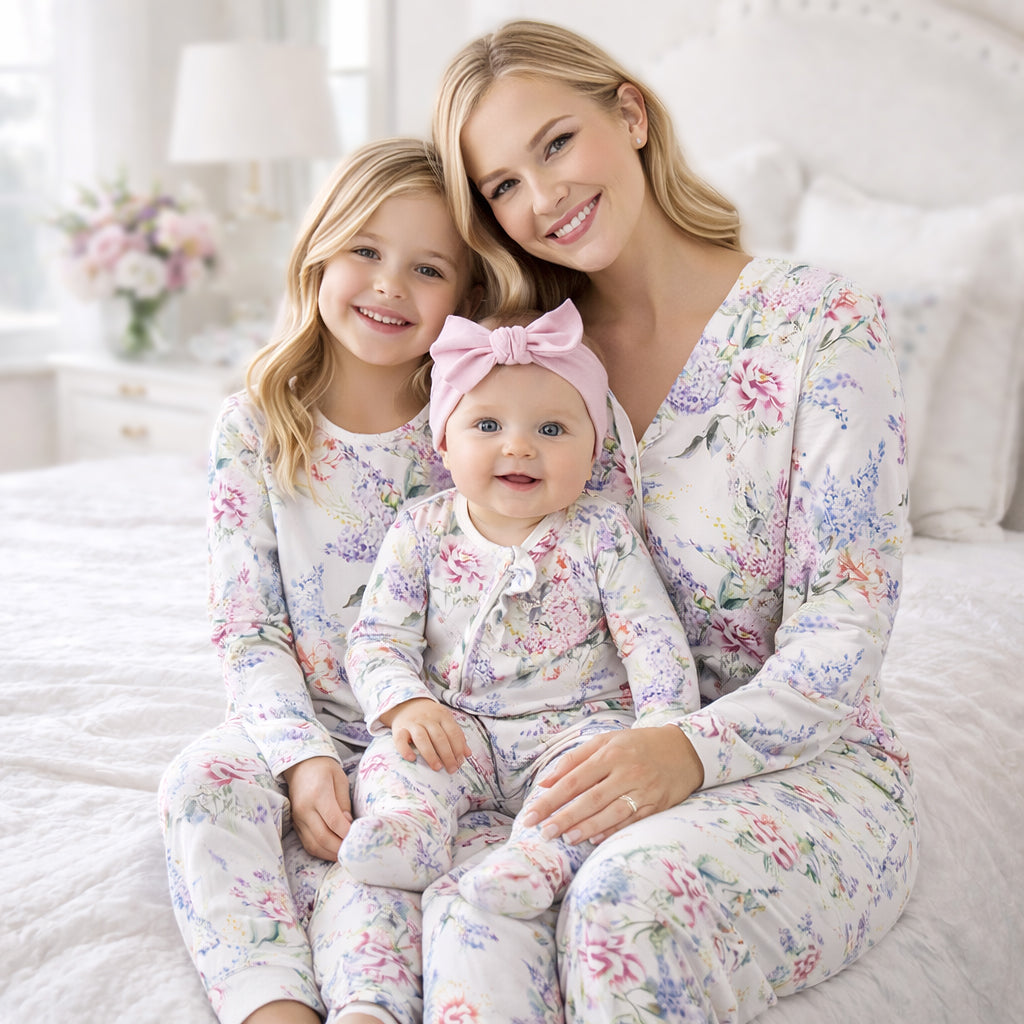 Matching kids pajama set with white floral print, long sleeves and long pants.