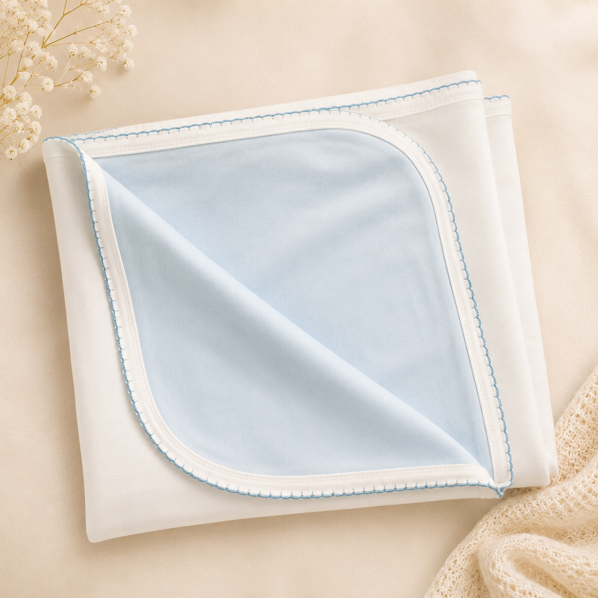 Reversible cotton blanket with baby-blue panel, white backing, and blue picot trim