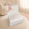 Muslin swaddle blanket in gift box, light pattern with soft floral branches