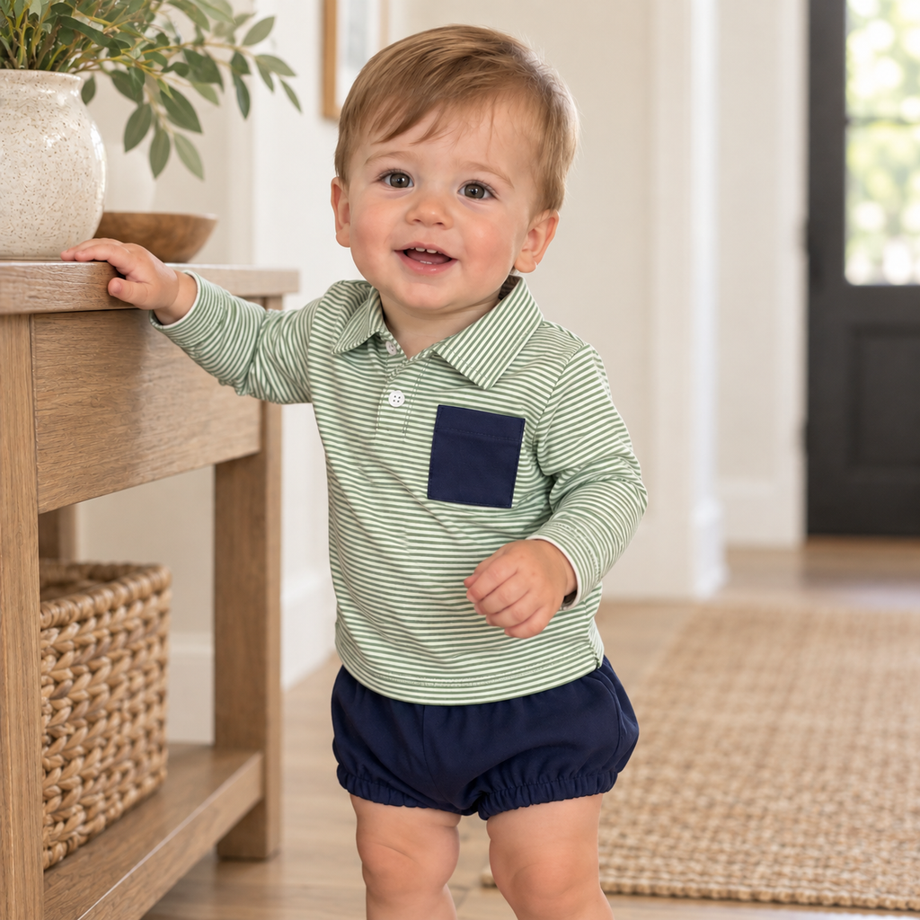 Boys striped long-sleeve polo with navy pocket and navy bubble shorts worn by toddler