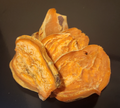 Dehydrated sweet potato dog chips, shown as thick orange slices.