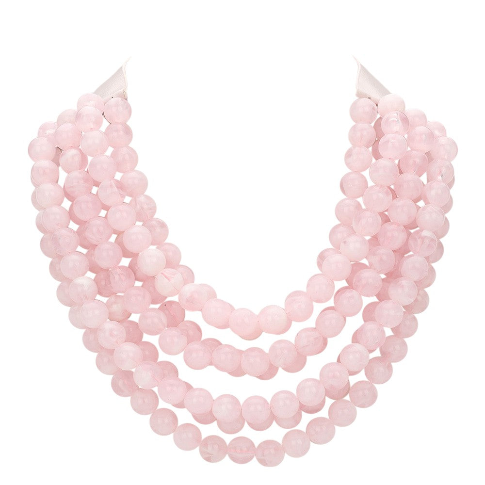 Chunky multi-strand beaded statement necklace in pale pink with soft layered look.