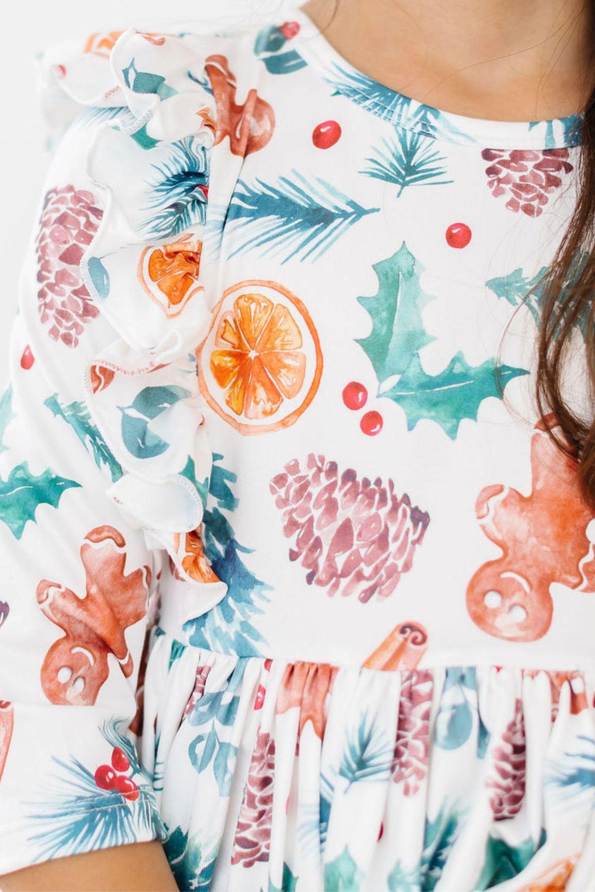 Close-up of kids Christmas print twirl dress with 3/4 ruffled sleeves and gathered waist