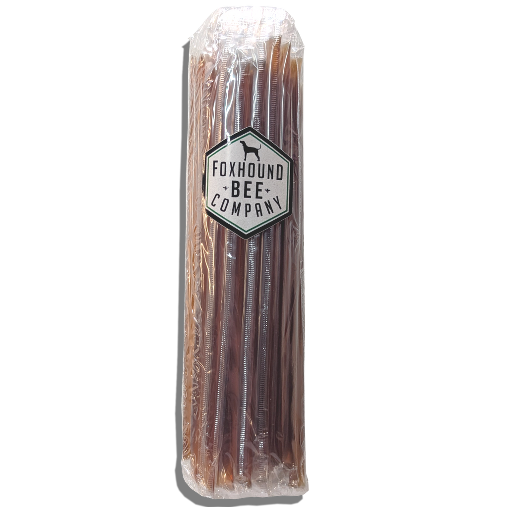 Single honey stick in dark brown color, sealed in clear plastic