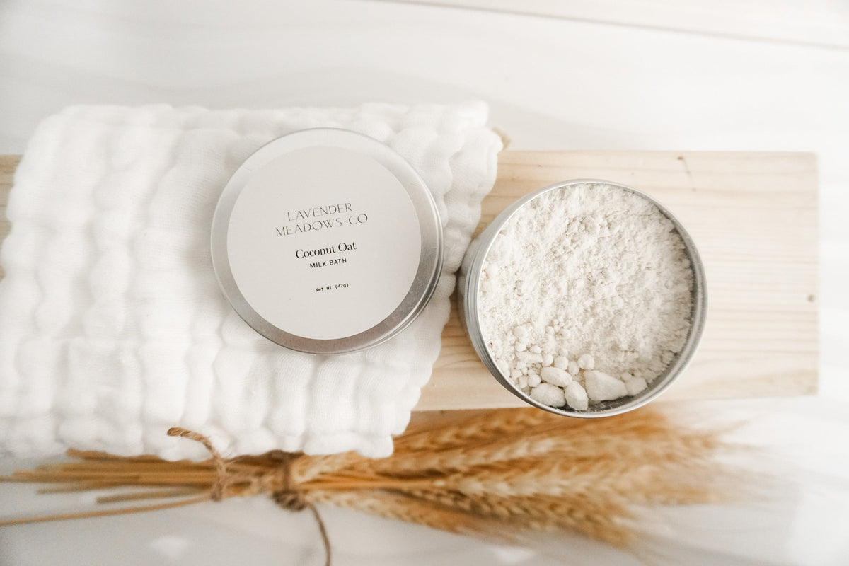 Lavender Meadows Co body tin and bowl of powder with muslin cloth and dried botanicals