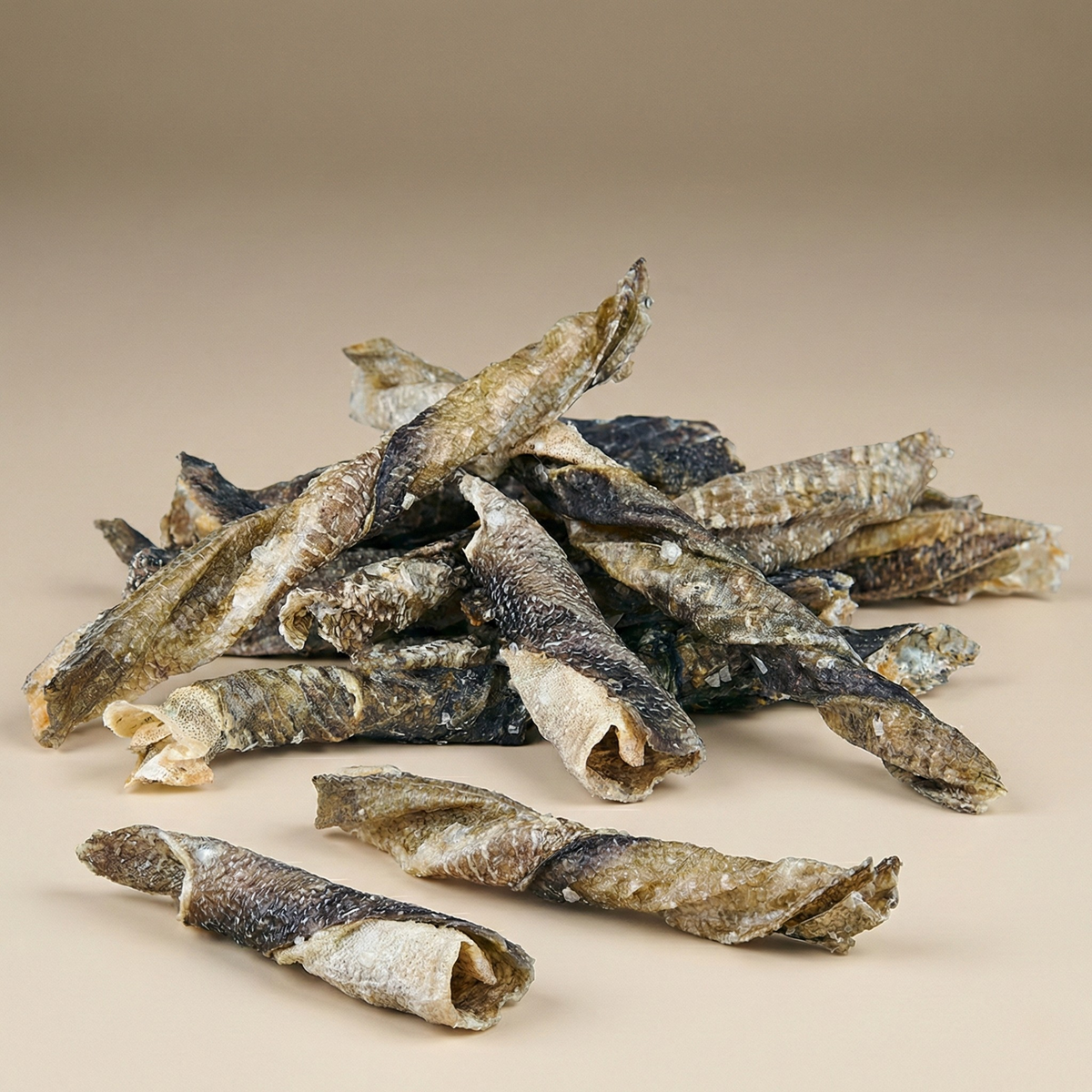 Pile of twisted fish jerky dog treats on a flat surface