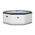 Octagonal eco foam hot tub in light pebble with open cover and clear water viewing area