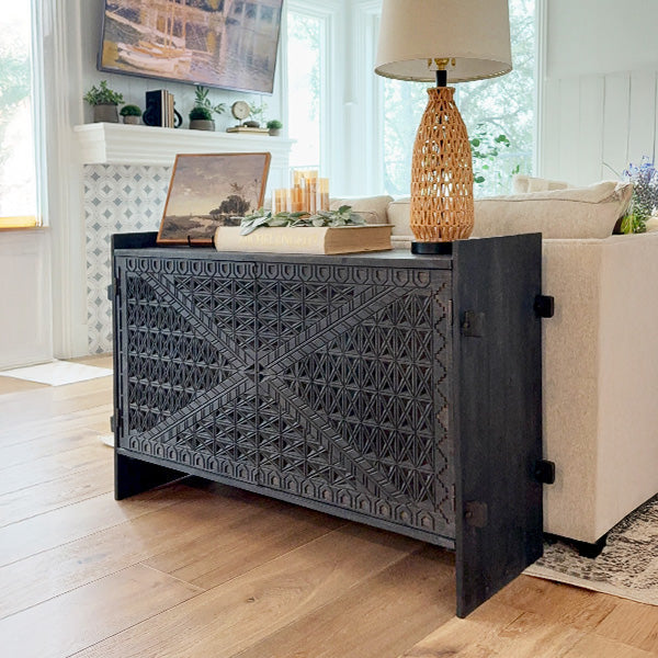 Dark wood console table with geometric carved front and side panel doors