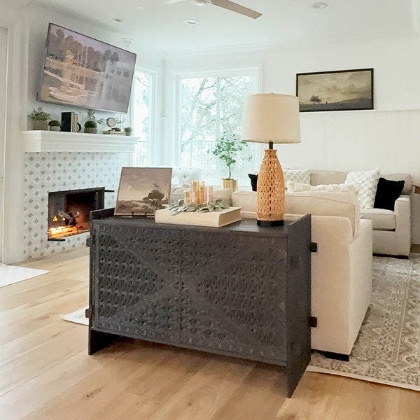 Dark wood console table with geometric carved front and two hinged doors