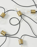 Solar string lights with clear bulbs and gold caps on black wire