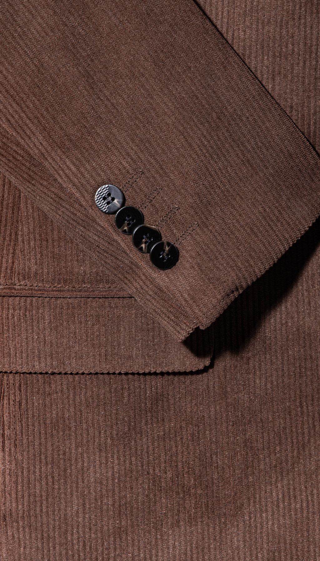 Brown corduroy blazer sleeve cuff with two-button detail