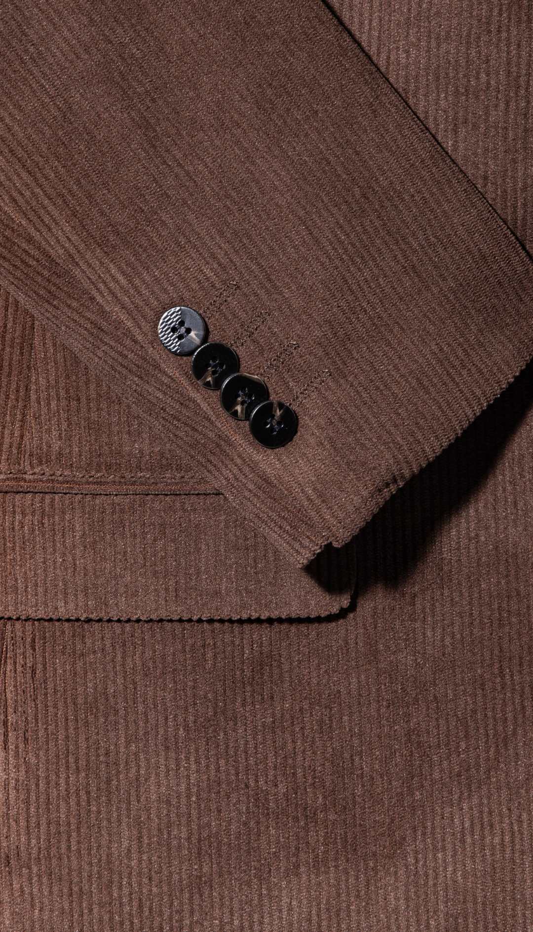 Brown corduroy blazer sleeve cuff with two-button detail