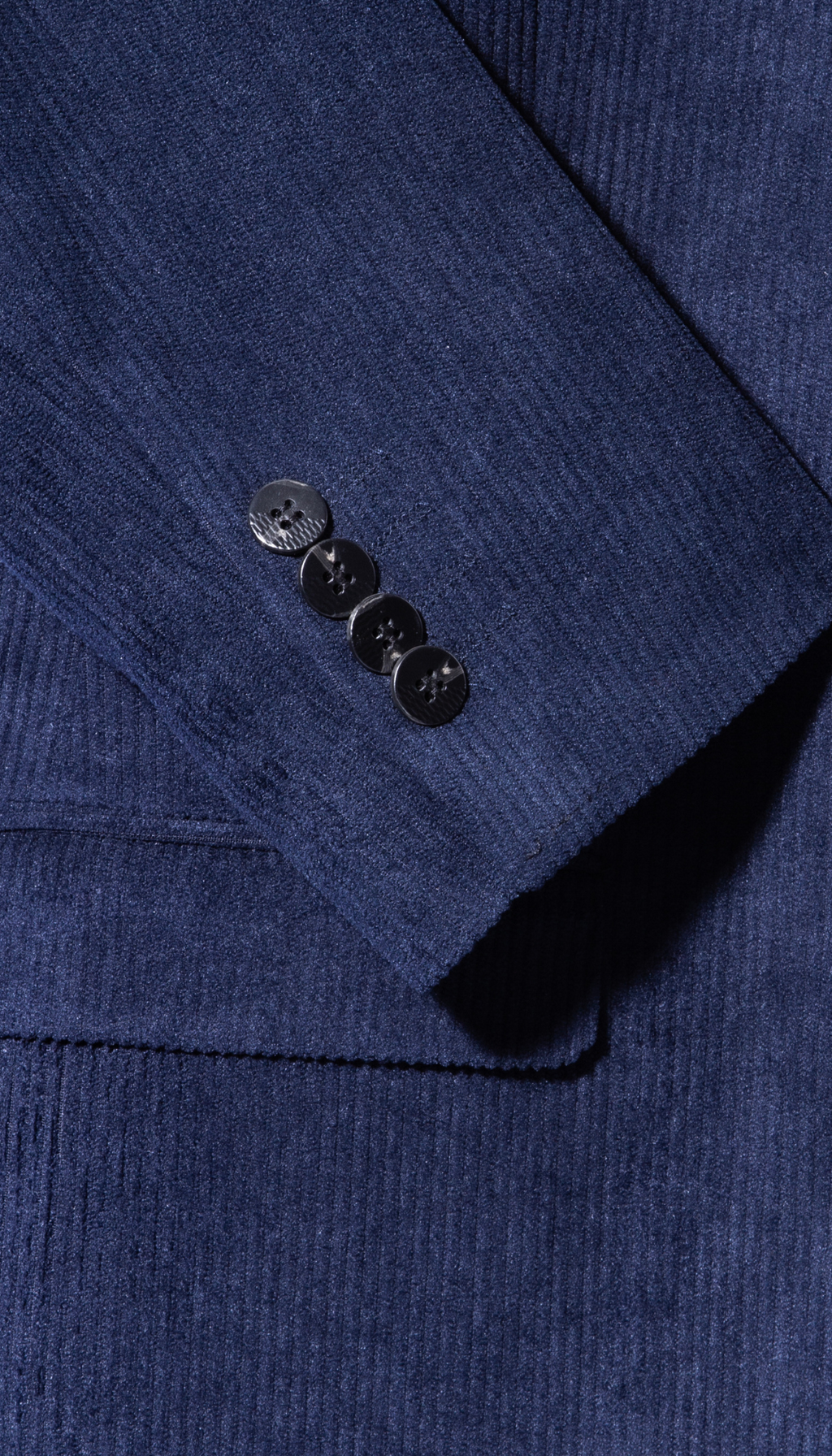 Navy corduroy suit sleeve cuff with three black buttons
