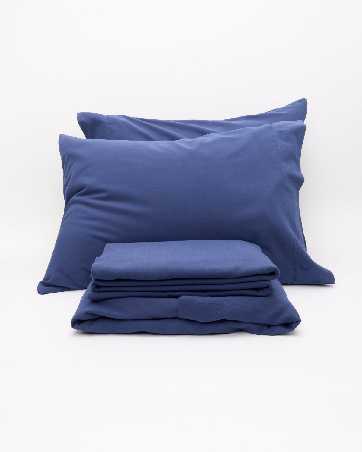 Blue pillowcases with neatly folded duvet cover set