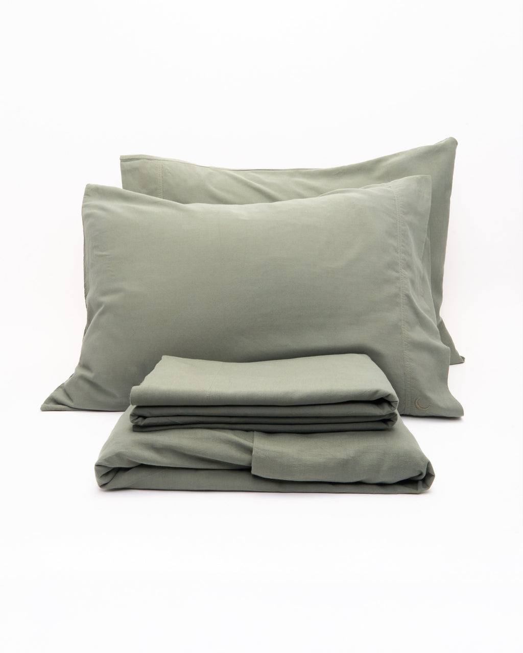 Sage green pillowcases stacked with folded sheets