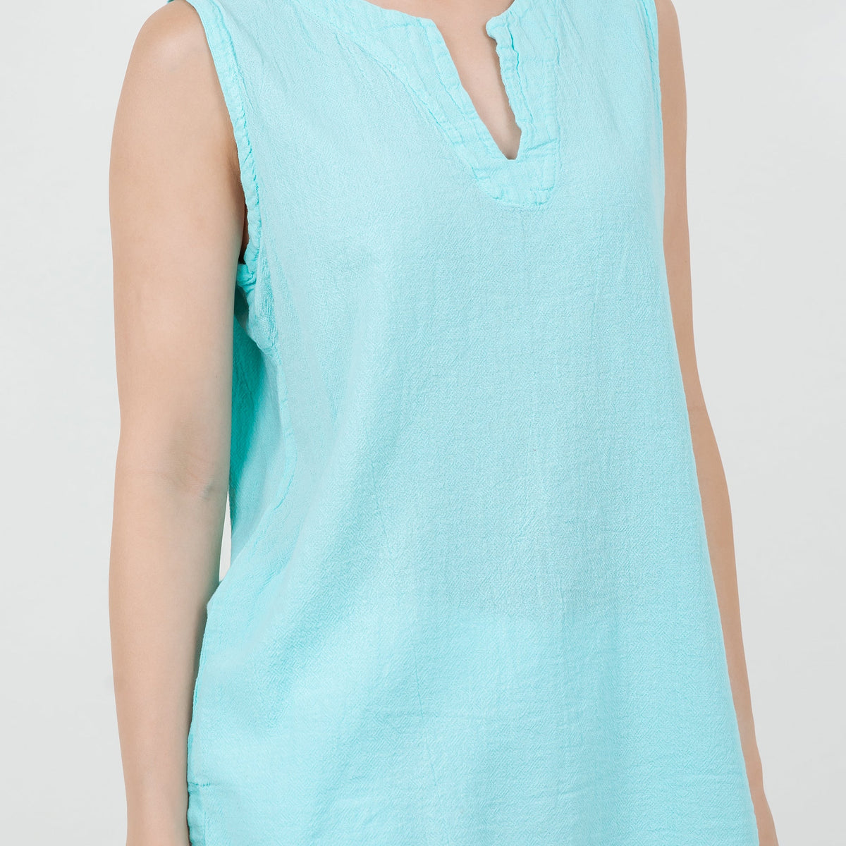 Light aqua cotton gauze sleeveless top, close-up of V-neck center opening