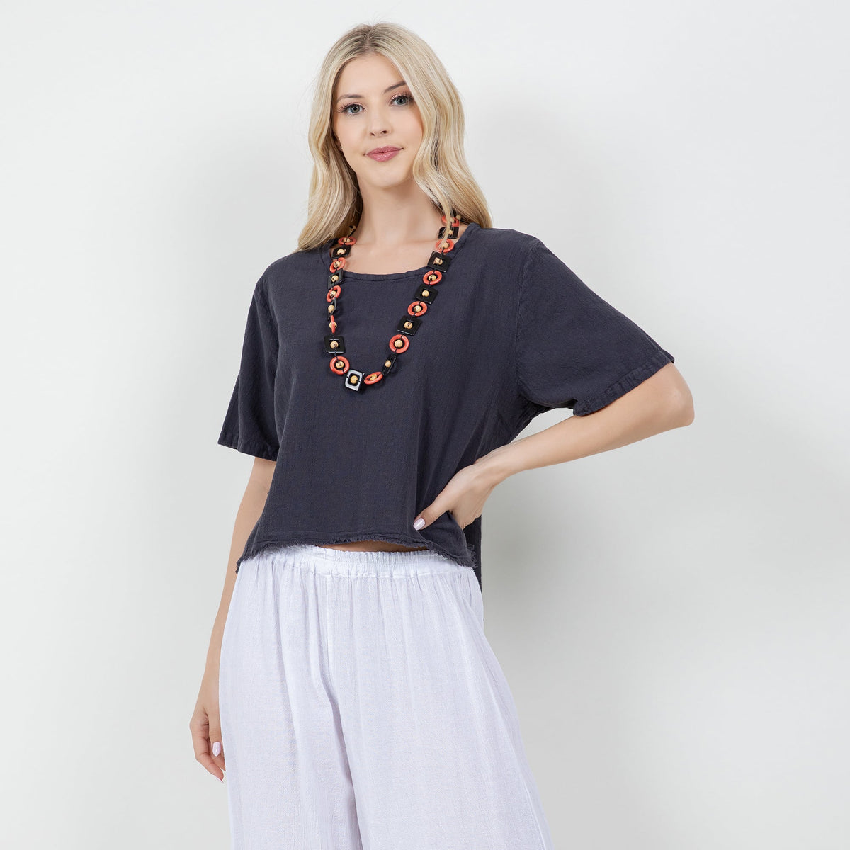 Women's gauze Heidi top, dark navy, raw hem; statement bead necklace visible