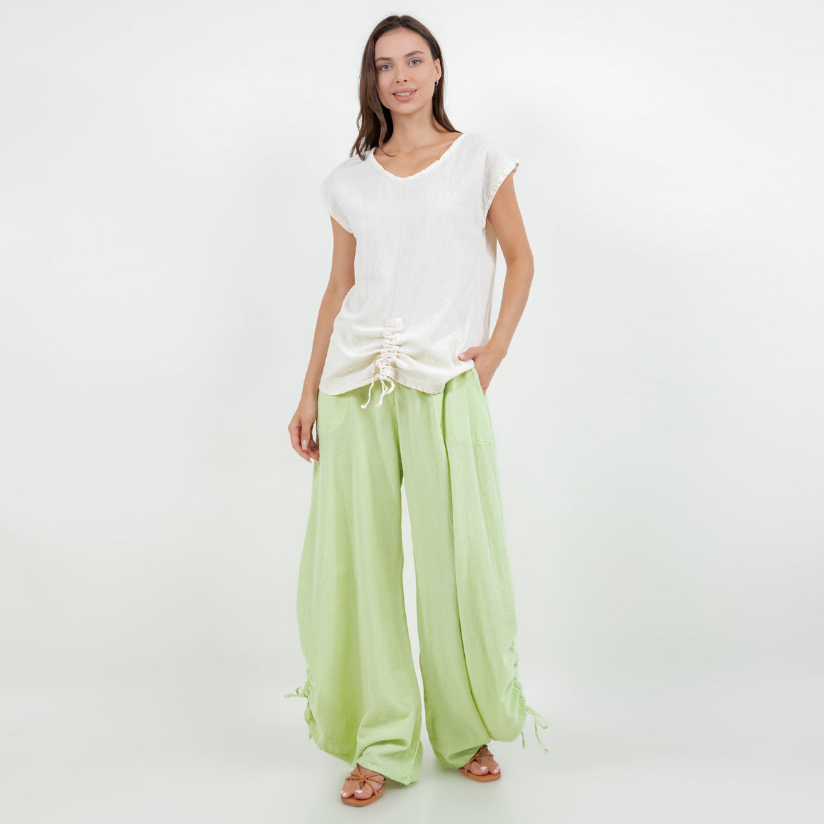 Lime green wide-leg cotton gauze pants with elastic waistband, side tie details at hem